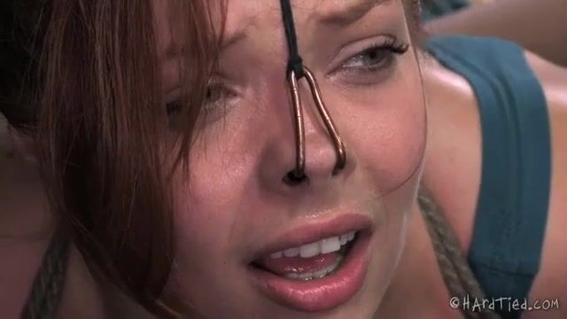 Связанная девушка подвергается легким сексуальным пыткам