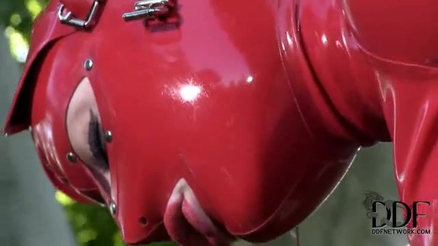 Баба в латексе мастурбирует пизденку пальцами на газоне